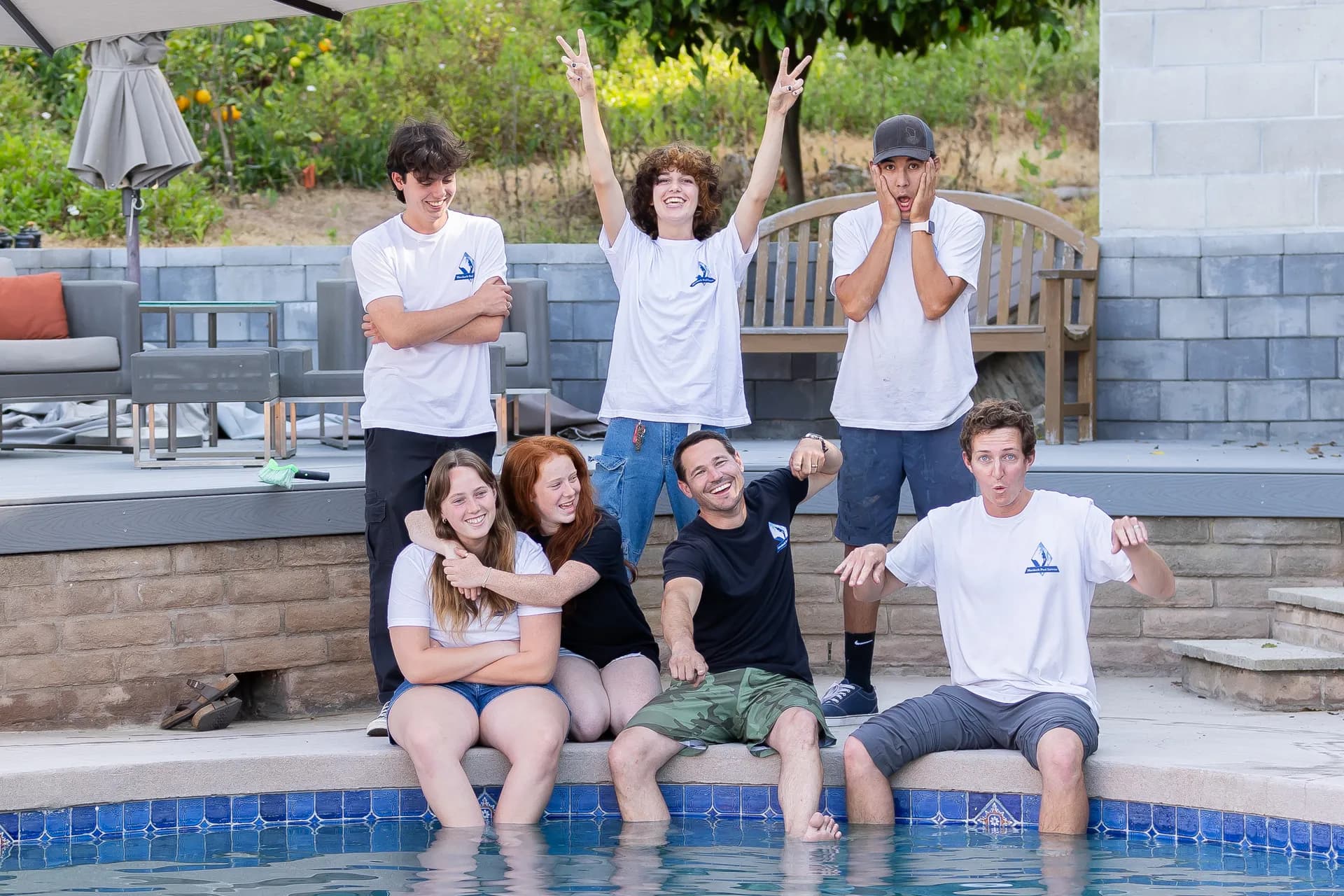 Team celebrating and making funny faces poolside