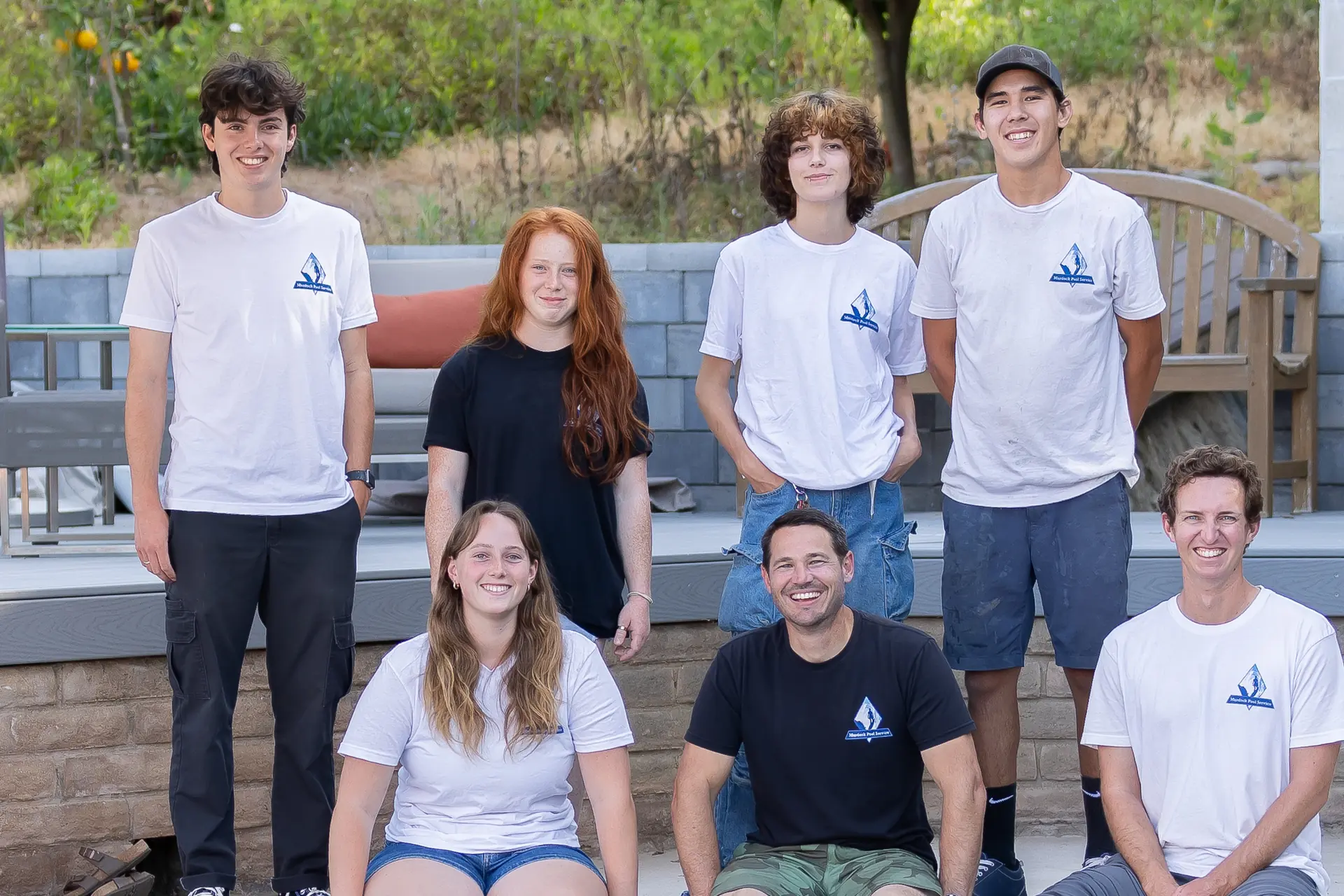 Murdock Pool Service team gathered on a backyard patio in San Diego