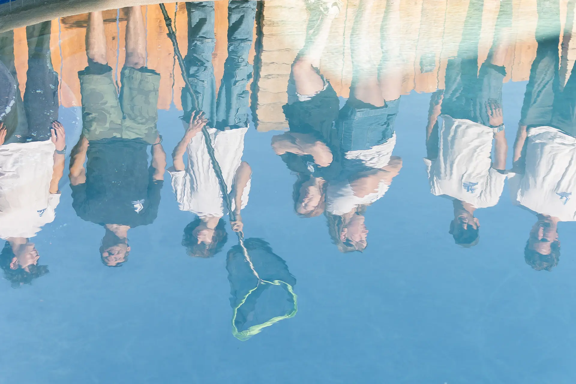 The team reflected in the surface of a freshly serviced pool in Bonita, San Diego County