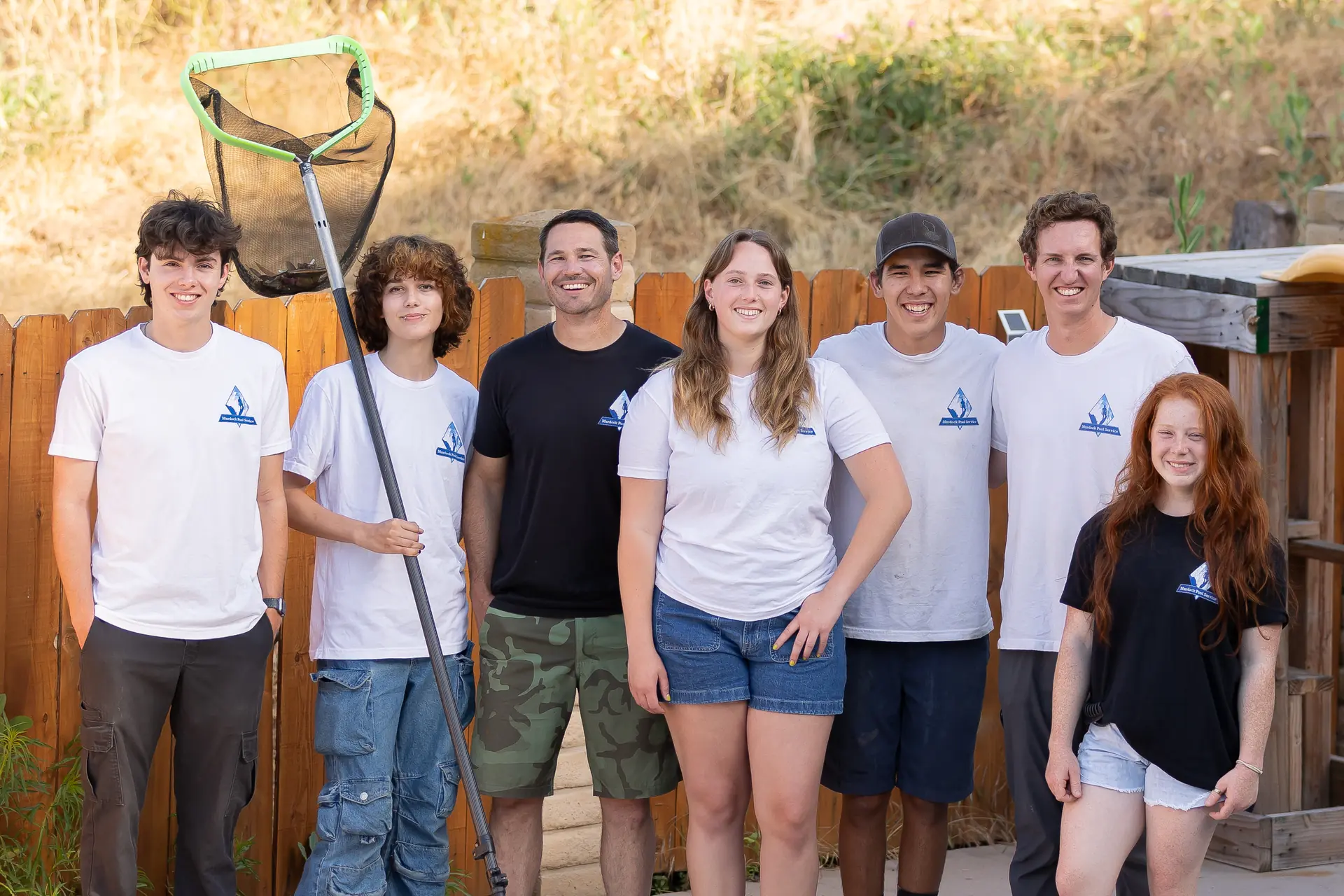Murdock Pool Service team posed together with cleaning equipment at a San Diego property